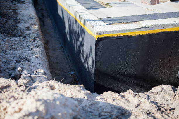Professional Basement Waterproofing technician working in Slayden, TN